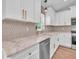 Close-up of a farmhouse sink with marble countertops and stylish fixtures in a modern kitchen at 13334 Sw 107Th St, Dunnellon, FL 34432