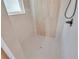 Modern shower featuring sleek fixtures, light-colored tiles, and a grey penny tile floor at 13334 Sw 107Th St, Dunnellon, FL 34432