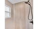 Modern shower featuring sleek fixtures, light-colored tiles, and a window for natural light at 13334 Sw 107Th St, Dunnellon, FL 34432