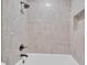 Close-up of a tiled shower-tub combination featuring sleek fixtures, and inset storage niche at 13334 Sw 107Th St, Dunnellon, FL 34432