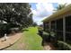 Expansive backyard featuring lush green lawns, manicured hedges, and mature trees creating a serene outdoor space at 1335 Eureka Mill Run, The Villages, FL 32162