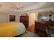 Spacious bedroom boasts wood floors, tray ceilings, and tasteful decor at 1335 Eureka Mill Run, The Villages, FL 32162
