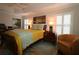Comfortable bedroom with wood floors, tray ceilings, plantation shutters, and stylish decor at 1335 Eureka Mill Run, The Villages, FL 32162
