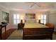 Inviting bedroom with wood floors, tray ceilings, plantation shutters, and stylish decor at 1335 Eureka Mill Run, The Villages, FL 32162
