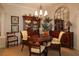 Elegant dining room featuring a round table, chandelier, and beautiful hutch with ample storage at 1335 Eureka Mill Run, The Villages, FL 32162