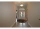 Elegant foyer with decorative double front doors, arched transom window, tile flooring, and a classic chandelier at 1335 Eureka Mill Run, The Villages, FL 32162