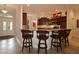 Stylish kitchen bar area features seating and seamlessly connects to the home's entry at 1335 Eureka Mill Run, The Villages, FL 32162