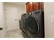 Convenient laundry room equipped with modern washer and dryer set and cabinet space at 1335 Eureka Mill Run, The Villages, FL 32162
