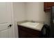 Functional laundry area features a utility sink and cabinet for added convenience at 1335 Eureka Mill Run, The Villages, FL 32162