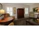 Cozy living room features a wooden armoire and comfortable seating, perfect for relaxation at 1335 Eureka Mill Run, The Villages, FL 32162