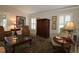 Inviting living room boasts a stylish rug and plush armchairs, ideal for entertaining guests at 1335 Eureka Mill Run, The Villages, FL 32162