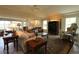 Comfortable living room with vaulted ceilings, plantation shutters, neutral colors, and access to outdoor areas at 1335 Eureka Mill Run, The Villages, FL 32162