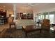Spacious living room featuring a plush sofa, glass-top coffee table, and stylish decor at 1335 Eureka Mill Run, The Villages, FL 32162