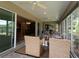 Enclosed patio showing dining area with comfortable seating options and views of the lush backyard at 1335 Eureka Mill Run, The Villages, FL 32162