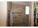 A tiled shower featuring multiple shower heads and a small obscured glass window at 1335 Eureka Mill Run, The Villages, FL 32162