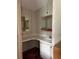 Vintage bathroom vanity area with wallpaper, mirrors, and a white sink at 1404 Plantation Dr # 9, Lady Lake, FL 32159