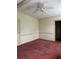 Simple bedroom design with red carpet, a closet and white walls and ceiling fan at 1404 Plantation Dr # 9, Lady Lake, FL 32159