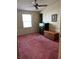Bright bedroom with a window, ceiling fan, and furnishings, with a pink carpet at 1404 Plantation Dr # 9, Lady Lake, FL 32159