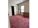 Bedroom with closet, wall mirror, dresser and red carpet at 1404 Plantation Dr # 9, Lady Lake, FL 32159
