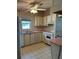Efficient kitchen with matching appliances and ample cabinet space and a window at 1404 Plantation Dr # 9, Lady Lake, FL 32159