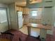 The kitchen has white cabinets, a refrigerator, and neutral flooring at 1404 Plantation Dr # 9, Lady Lake, FL 32159