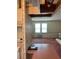 Open living space adjacent to kitchen, bathed in light from two large windows at 1404 Plantation Dr # 9, Lady Lake, FL 32159
