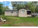 Expansive backyard view showcasing the home's exterior, lush lawn, and peaceful surroundings at 1436 Spring Lake Rd, Fruitland Park, FL 34731