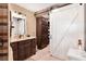 Elegant bathroom featuring dark wood cabinets, a vanity, a walk-in closet, and tile floors at 1436 Spring Lake Rd, Fruitland Park, FL 34731