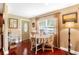 Cozy breakfast nook features a window with natural light, a table set for four, and hardwood floors at 1436 Spring Lake Rd, Fruitland Park, FL 34731