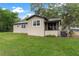 Charming home with a metal roof, quaint screened porch, and lush lawn at 1436 Spring Lake Rd, Fruitland Park, FL 34731