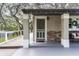 Close-up of the home's front entrance, featuring a porch with decorative pillars and stone accents at 1436 Spring Lake Rd, Fruitland Park, FL 34731