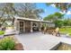 Inviting front porch with seating and manicured landscaping offers a welcoming entrance to the charming home at 1436 Spring Lake Rd, Fruitland Park, FL 34731