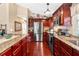 This updated kitchen features granite counters, stainless appliances, and dark wood cabinets at 1436 Spring Lake Rd, Fruitland Park, FL 34731