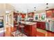 Spacious kitchen boasts stainless steel appliances, a center island, and rich wood cabinetry at 1436 Spring Lake Rd, Fruitland Park, FL 34731