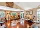 Inviting living room features hardwood floors, French doors, and cozy seating with a spacious, open design at 1436 Spring Lake Rd, Fruitland Park, FL 34731