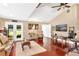 Open-concept living room with hardwood floors, vaulted ceiling, and French doors leading to the outdoors at 1436 Spring Lake Rd, Fruitland Park, FL 34731