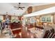 Cozy living room flows into the modern kitchen, featuring an open-concept design with warm hardwood floors at 1436 Spring Lake Rd, Fruitland Park, FL 34731