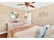 This comfortable bedroom features a ceiling fan and plush carpet, creating a relaxing retreat at 1436 Spring Lake Rd, Fruitland Park, FL 34731