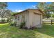 Outbuilding features a garage door and adjacent decorative wooden ladder at 1436 Spring Lake Rd, Fruitland Park, FL 34731