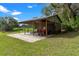 Open-sided shed with concrete base, tractor and lawn maintenance equipment at 1436 Spring Lake Rd, Fruitland Park, FL 34731
