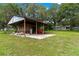Open-sided shed with concrete base, tractor and lawn maintenance equipment at 1436 Spring Lake Rd, Fruitland Park, FL 34731