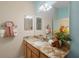 Bathroom featuring granite countertop, modern fixtures, and a spacious mirror, offering style and functionality at 1664 Vinewood Ave, The Villages, FL 32162