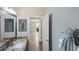 Bathroom featuring a sink with granite counters, a view to another room, and neutral walls at 1664 Vinewood Ave, The Villages, FL 32162
