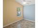 Bright bedroom with a window, ceiling fan, and neutral color palette, creating a comfortable space at 1664 Vinewood Ave, The Villages, FL 32162