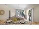Bright dining area with contemporary finishes, flowing into the living room, and featuring a seamless connection to the outdoor patio at 1664 Vinewood Ave, The Villages, FL 32162