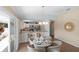 Bright dining space featuring a modern chandelier, seamlessly connected to an open kitchen and providing access to the outdoor patio at 1664 Vinewood Ave, The Villages, FL 32162