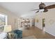 Spacious living area with open floor plan, flowing into the dining space and kitchen, flooded with natural light from large windows at 1664 Vinewood Ave, The Villages, FL 32162