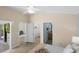 Bedroom featuring multiple doorways including access to the closet, bathroom, and outdoor patio at 1664 Vinewood Ave, The Villages, FL 32162