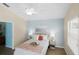 Well-lit bedroom with a ceiling fan, blue accent wall, and two side tables with lamps at 1664 Vinewood Ave, The Villages, FL 32162