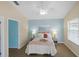 Bright bedroom featuring a ceiling fan, blue accent wall, and natural lighting from the window at 1664 Vinewood Ave, The Villages, FL 32162
